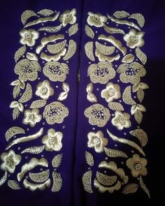 two pieces of cloth with gold flowers and leaves on purple fabric, one piece has been cut