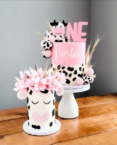 two cakes decorated with pink and black polka dots, one has a name on it