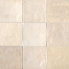 a white tiled wall with several different colors