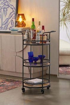 a bar cart with drinks on it in a living room