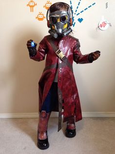 a person in a costume standing next to a wall