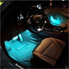 the interior of a car is lit up with blue lights