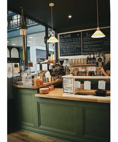 a counter with menus on it and lights hanging from the ceiling in a restaurant