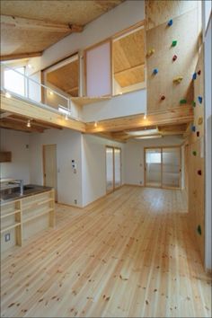 an empty room with wood floors and climbing walls