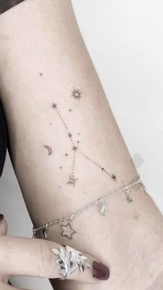 a woman's arm with a star and moon tattoo on the left side of her body