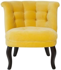 a beige chair with black legs and a buttoned back