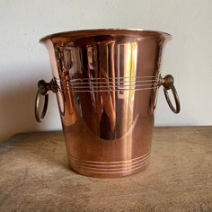 a large metal cup sitting on top of a table