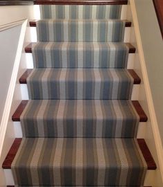 the stairs are lined with blue and white checkered carpet