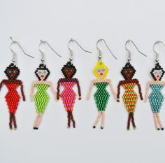 five beaded earrings with different designs on them, each featuring a woman in a dress