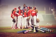 a group of baseball players standing on top of a field