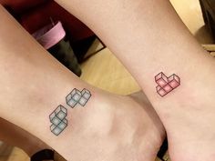 two people with matching tattoos on their feet