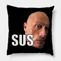 a black pillow with the words sus printed on it and a bald man's face