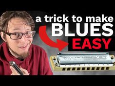 a man is holding a harmonica in front of him and has the words blues easy on it