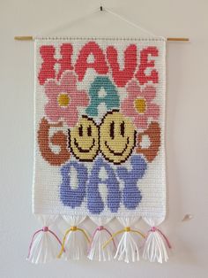 there is a cross stitch wall hanging with the words have a good day on it