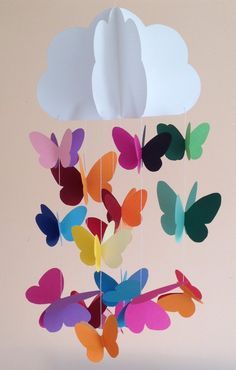 a mobile made out of paper with colorful butterflies hanging from it's sides in the shape of a cloud