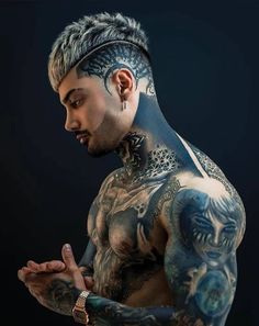 a man with tattoos and piercings on his chest is looking down at his hand