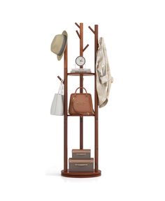 a coat rack with hats, purses and other items on it in front of a white background