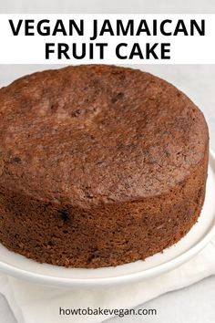 a close up of a cake on a plate with the words vegan jamaican fruit cake