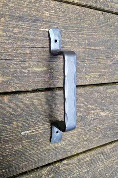 a metal handle on the side of a wooden building