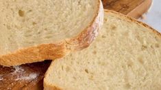 two pieces of bread sitting on top of a cutting board