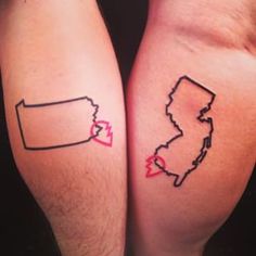 two people with matching tattoos on their legs, one has a heart and the other has a map