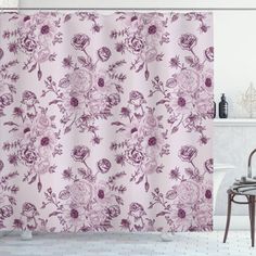 a bathroom with a bathtub, shower curtain and rug in purple flowers on a pink background