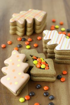 decorated cookies and candies on a wooden table