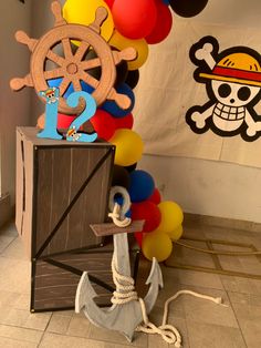 a pirate themed birthday party with balloons and balloon decorations, including a ship steering wheel