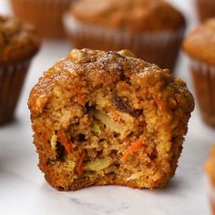 a muffin that has been cut in half and is sitting on a table with other muffins