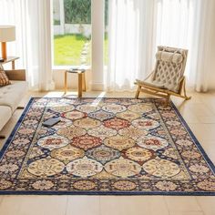 a living room with a large rug on the floor