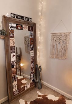 a mirror sitting on top of a floor next to a cow skin rug and lights