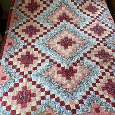 an old quilt is laying on a bed