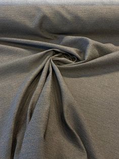 a close up view of a plain grey fabric