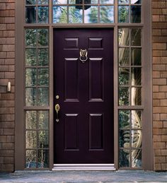 a purple front door with glass panes