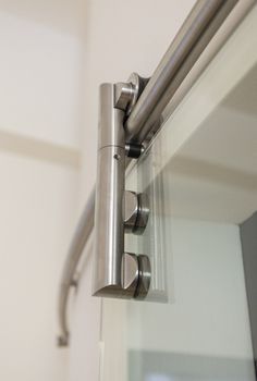 a close up view of a sliding glass door with stainless steel handles and bars on it