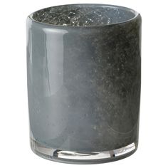 a gray glass vase with silver trim on the top and bottom is filled with black speckles