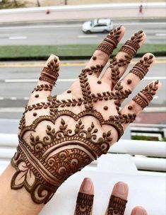 a hand with henna on it that is showing the intricate pattern and design,