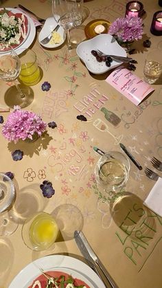 a table topped with plates and glasses filled with food