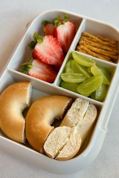 a plastic container filled with assorted food items on top of a white countertop