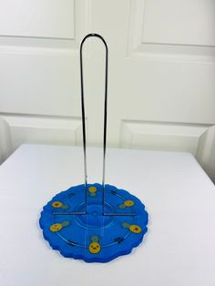 a blue frisbee holder sitting on top of a white table