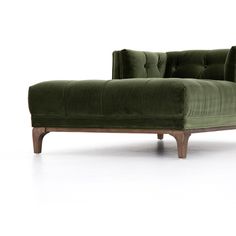 a green velvet chaise lounge chair with wooden legs and arms, viewed from the front