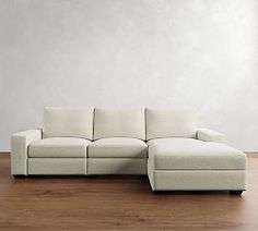 a white couch sitting on top of a wooden floor