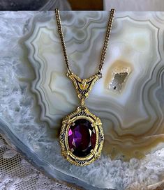 Featuring an exquisite HFB Barrows 1890s gold rolled Pinchbeck black enamel Taille d'Epargne work amethyst purple paste stone accented set in an open back pronged setting .  Necklace measures approximately 15 inches around with a 1.9 inch pendant drop at 7.26 grams respectively and is  in excellent antique condition with a functional hallmarked thumbless clasp , normal wear with all stones intact and accounted for.  Stamped HFB on the clasp. Elegant and beautifully designed and worn over a hundred years ago! Please feel free to contact me with any questions or suggestions I'm always learning  (Box not included) Amethyst Purple, Purple Stones, Screw Back Earrings, Black Enamel, Open Back, Screw, Necklace Etsy, Gold Necklace, Amethyst