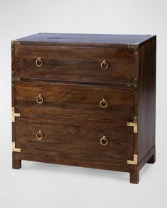 a wooden chest with brass handles and two drawers on one side, against a white background