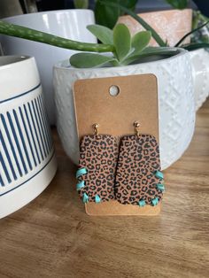 These are mocha brown clay earrings with a gold ball stud, turquoise leather and black cheetah print. Chic Handmade Brown Jewelry, Chic Brown Handmade Jewelry, Trendy Leopard Print Dangle Earrings, Trendy Leopard Print Dangle Jewelry, Trendy Brown Jewelry With Ear Wire, Western Diy, Black Cheetah Print, Brown Clay, Work Badge