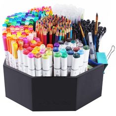 a black container filled with lots of different colored crayons and pens on top of each other