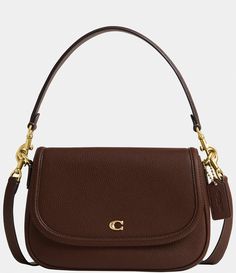 From COACH&#x2C; the Legacy Small Pebbled Leather Shoulder Bag features: Featuring a COACH logo flap&#x2C; this Legacy shoulder bag sits just beneath the underarm with the shorter strap or it can be worn as a crossbody. Small-sized bag; 10" W x 7.25" H x 2.75" D (width is measured across the bottom of handbag); 1.32 lbs. approx. weightApprox. 7.5" L removable short strap; 21.5" L removable crossbo Staple Designer Bags, Fall Shoulder Bag, Coach Small Purse, Brown Coach Shoulder Bag, Everyday Designer Handbags, Date Night Purse, Coach Shoulder Purse, Small Coach Purse, Cute Everyday Purse