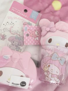 the hello kitty cup and its matching accessories are in plastic packaging on a pink blanket