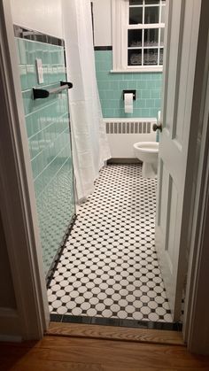 a bathroom with blue and white tiles on the floor