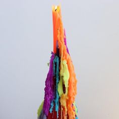 a multicolored candle sticking out of the ground